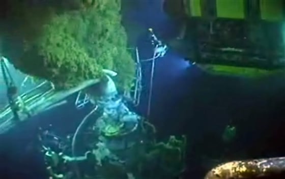 This image made from a BP video June 2 shows underwater robots and other equipment swarming a blowout preventer, bottom left, as oil rises at the site of the Deepwater Horizon oil spill.